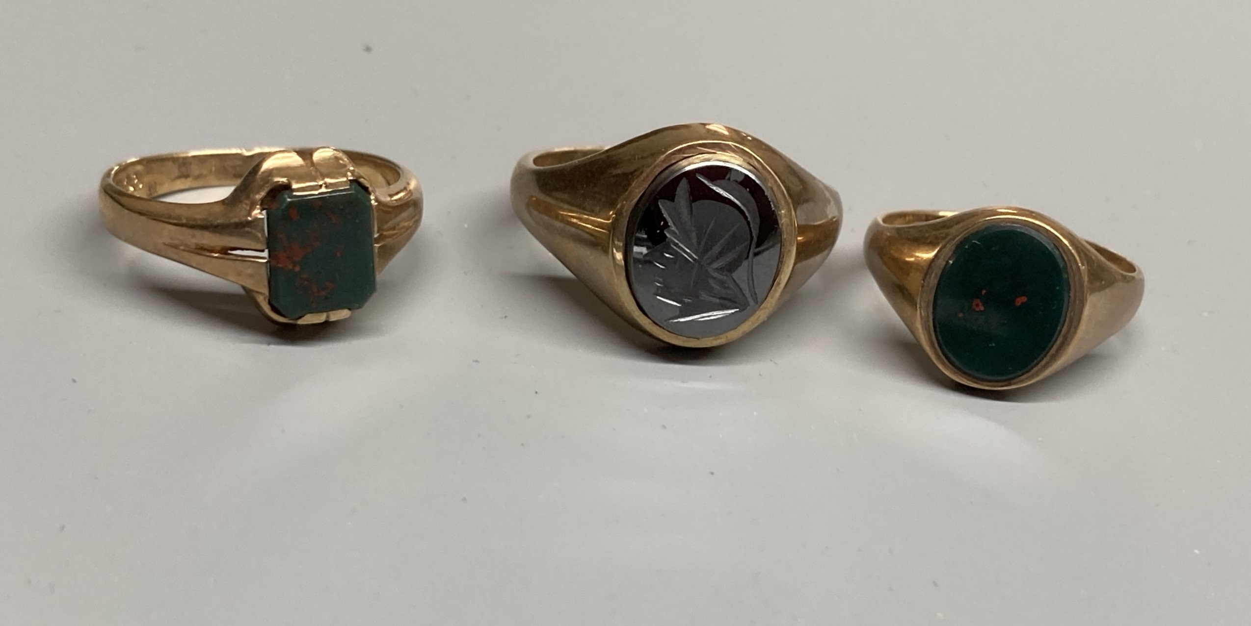 Two modern 9ct gold and bloodstone set signet rings, sizes M & T and a 9ct gold and hematite ring, size S/T